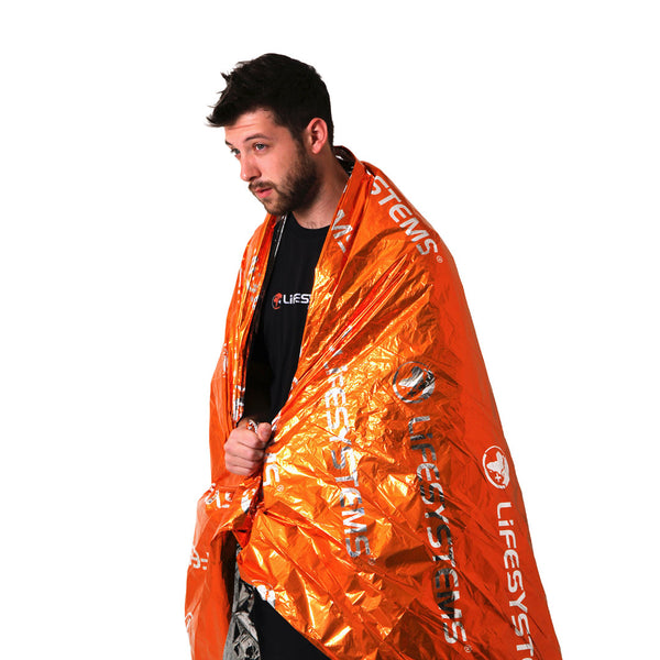 Lifesystems thermal survival space blanket being worn by a man