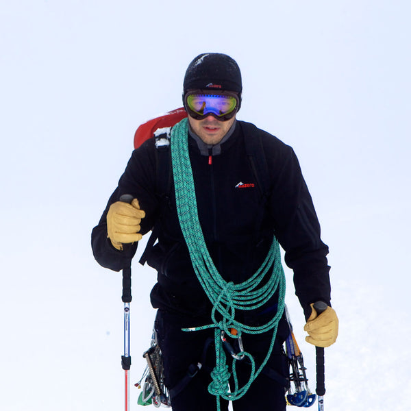 Lifestyle image of a man wearing a Sub Zero windproof softshell jacket whilst cross country skiing in winter